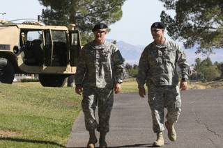 Sgt. Chris Sackett and PFC Arthur Schell, of the Army National Guard I-Troop 1-221 CAV, walk along the fairways greeting veterans and golfers during the Birdies for the Brave tournament at TPC Summerlin Golf Course Tuesday.