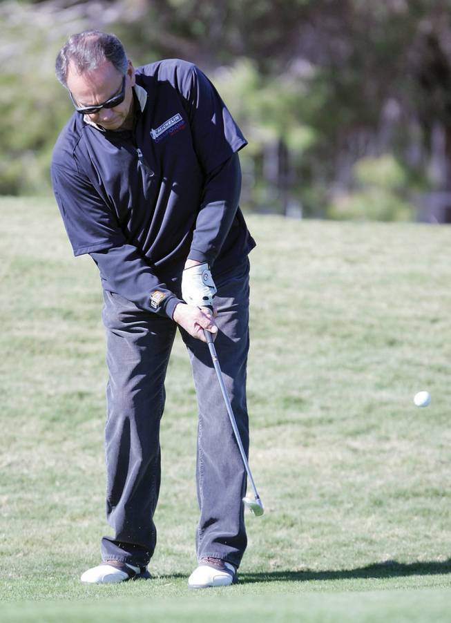 Henderson Mayor James Gibson plays a round of golf at Wild Horse golf course during the Henderson Senior Center Auxiliary's second annual golf fundraiser on Friday.