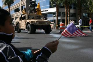 A young patriot waves a flag for veterans at the annual Veterans Day parade Tuesday.