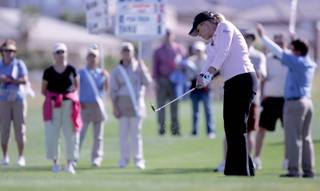 With a crowd of spectators watching, Christie Kerr sends the ball flying towards the 10th hole during the Wendy's 3-Tour Challenge at the Rio Secco Golf Club on Tuesday.  
