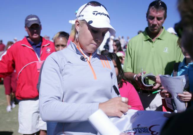 Natalie Gulbis signs autographs for adoring fans during her third consecutive appearance at the Wendy's 3-Tour Challenge at the Rio Secco Golf Club on Tuesday.  
