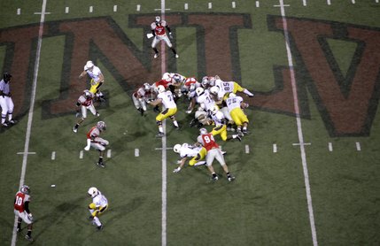 Tashaun Gibson of Wyoming finds a hole in UNLV's line.