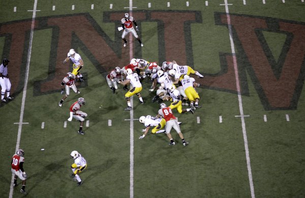 Tashaun Gibson of Wyoming finds a hole in UNLV's line.