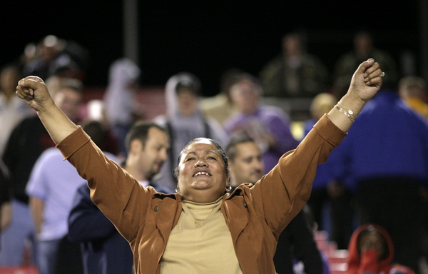A Rebels fan cheers on the team Thursday night as ...