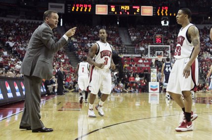 UNLV head coach Lon Kruger talks to players guard Tre'Von Willis, right and Mareceo Rutledge during the first half of their game against San Diego Saturday, Nov. 15, 2008. UNLV won the season opener 65-60. 