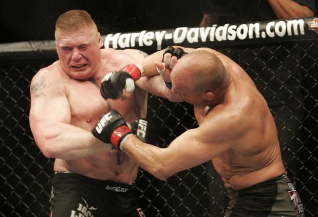 Heavyweight champion Randy Couture, right, and Brock Lesnar trade punches during their title fight Saturday, November 15, 2008 at the MGM Grand Garden Arena. Lesnar won by TKO in the second round.