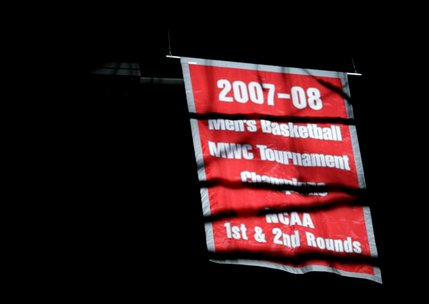 Last years banner is raised before the season opener begins.