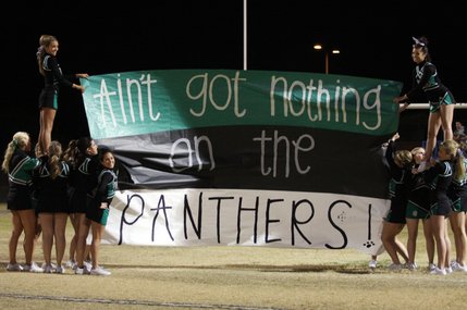 The Palo Verde Cheerleaders prepare the banner for the football team to run through during the Sunset Regional semifinals against Cimarron-Memorial at Palo Verde High School on Friday.
