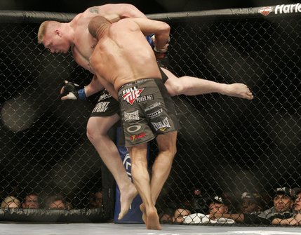 Randy Couture tries to throw Brock Lesnar to the mat during their heavyweight title fight Saturday at the MGM Grand Garden Arena. Lesnar won by TKO in the second round.