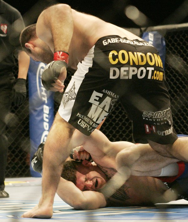 Gabriel Gonzaga pounds Josh Hendricks just before the referee steps ...