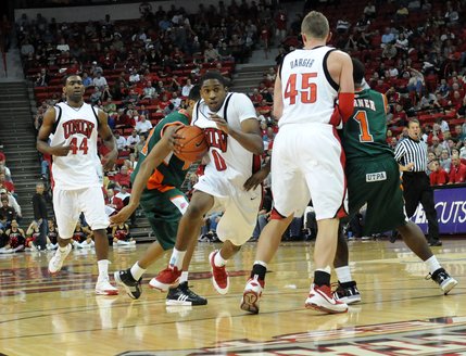Oscar Bellfield tucks the ball in as he blows past the Broncos' defense.
