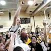 Team manager Jason McElwain, who has come to be known as J-Mac, is hoisted by his teammates after he scored 20 points in the final minutes of the final home game of the 2006 season. J-Mac will make an appearance this week in Las Vegas. 
