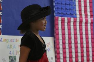 First-grader Mia Edwards plays the character of Mya Angelou, a poet, actress and important woman in the American civil rights movement, during the 16th annual Famous American Day at Lake Mead Christian Academy Friday.