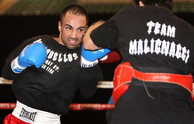 Junior welterweight boxer Paulie Malignaggi, left, of New York works on his timing with assistant trainer Orlando Carrasquillo at the MGM Grand Garden Arena in Las Vegas, Nevada Tuesday, November 18, 2008.
