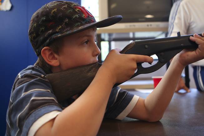 With steady hands, Aaron Kehoe, 9, aims at his paper turkey while competing Tuesday in the annual Turkey Shoot at the Boulder City Recreation Center.