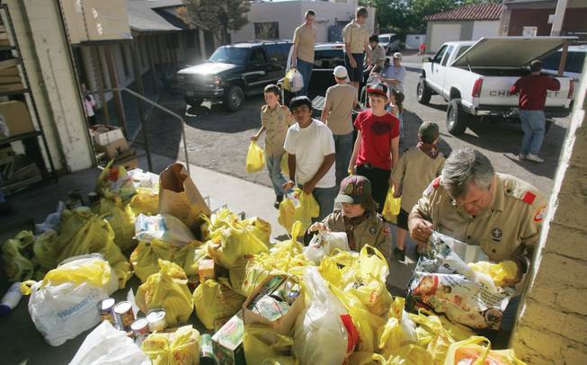Boy Scouts drop off loads of donated food as part of their holiday food drive at the Emergency Aid office in Boulder City to be sorted on Saturday.