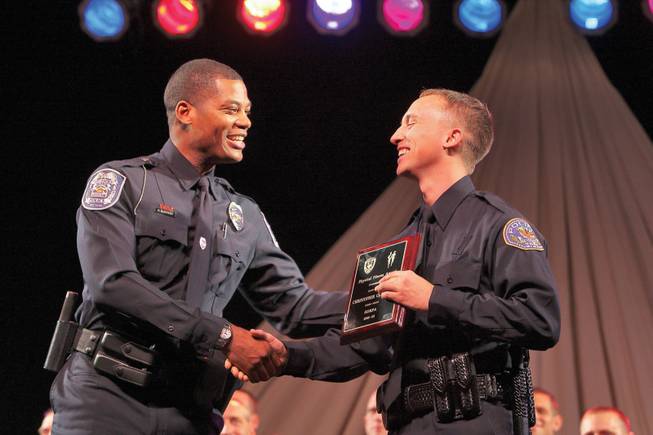 As recipient of the Class of 2008-02 Physical Fitness Award, Henderson Police Officer Christopher Gerhardt is congratulated by North Las Vegas TAC Officer Donavan McIntosh during the Southern Desert Regional Police Academy commencement ceremony.