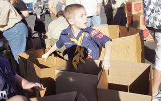 Herbie Ferree, from Pack 304, loads up with boxes to sort and pack food collected by Boy and Cub Scouts as part of their holiday food drive at the Henderson Salvation Army on Saturday.