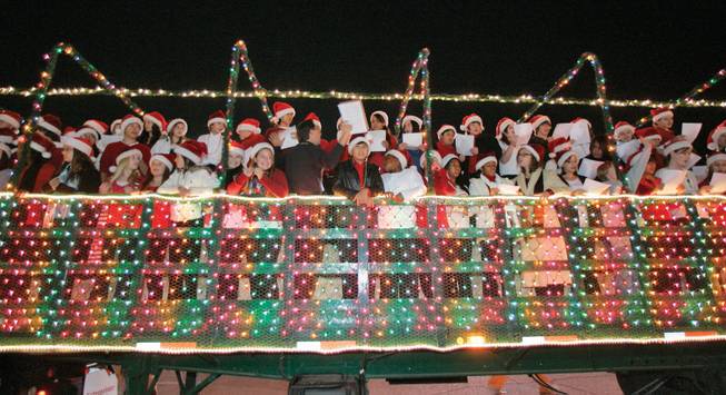 The Schofield Middle School choir, left, joined by Thurman White Middle school choir, right, sings Christmas carols on a hay ride Nov. 11, 2008, at the eighth annual Gift of Lights holiday light festival at Sunset Park.