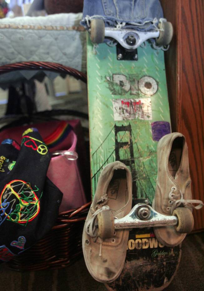 With a pair of worn out tennis shoes tucked beneath its wheels, Olivia "Lynn" Brandise Hyten's skateboard sits on display Wednesday during her funeral. Services were held at Palm Mortuary in Green Valley.