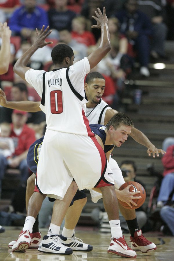 UNLV's Oscar Bellfield and Rene Rougeau pressure Northern Arizona forward ...