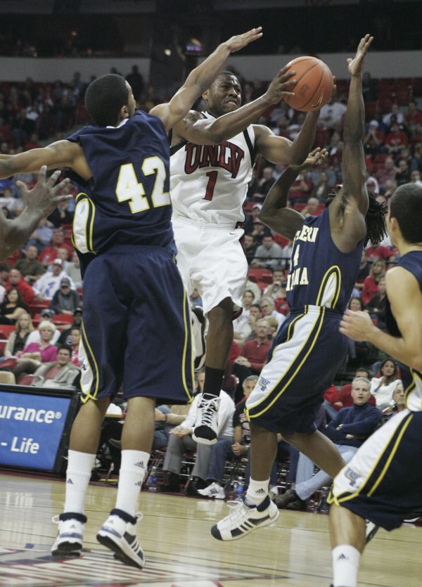UNLV guard Wink Adams drives past Northern Arizona's Josh Lepley, ...