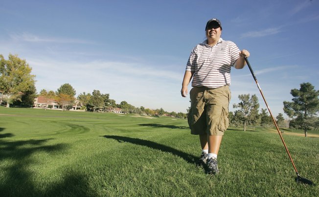 Kari Higa, 33, poses for a portrait at Spanish Trail Golf Course. One of the best amateur golfers in the city, Higa recently won the Spanish Trail Club Championship. 
