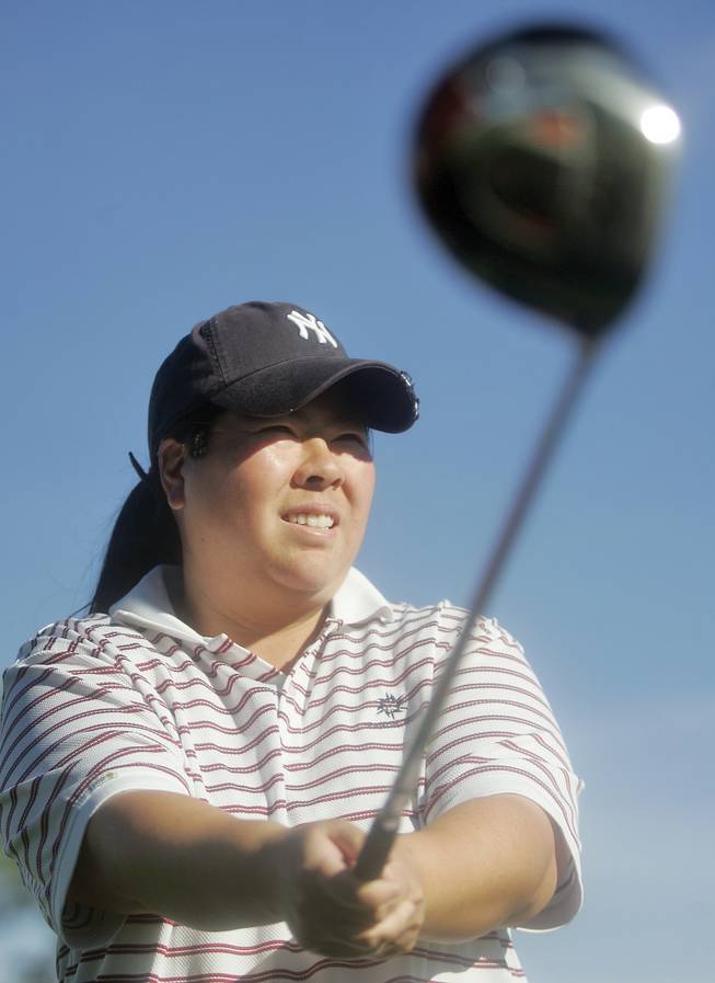 Kari Higa, 33, poses for a portrait at Spanish Trail Golf Course on. One of the best amateur golfers in the city, Higa recently won the Spanish Trail Club Championship. 