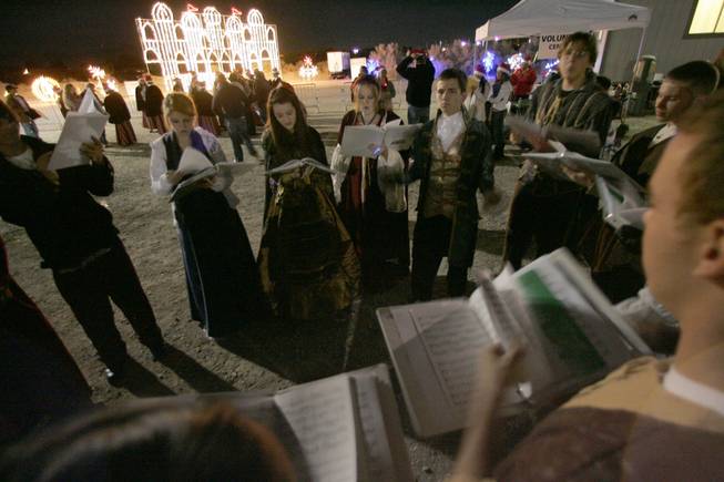 Members of the Coronado High Madrigals warm up before singing Christmas carols Nov. 11, 2008, at Sunset Park's Gift of Lights holiday light festival.