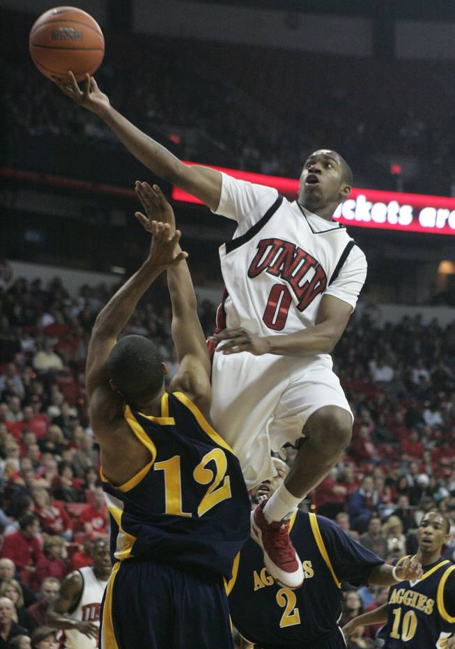 UNLV guard Oscar Bellfield flies over North Carolina A&T guard Nic Simpson for two points during the first half of their game Saturday.