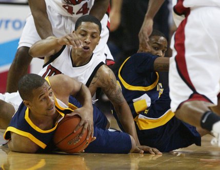 UNLV guard Tre'Von Willis and North Carolina A&T forward Kam Shepherd fight for a loose ball during the first half Saturday.