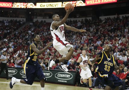UNLV guard Wink Adams splits North Carolina A&T forwards Ed Jones, left, and Nicholas Wilson during the second half of their game Saturday at the Thomas & Mack Center. UNLV won 71-58 and improved to 4-0. 