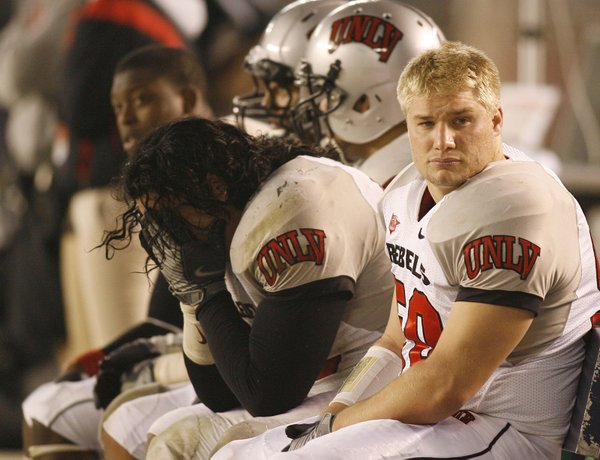 UNLV's Malo Taumua, center, holds his head in his hands ...