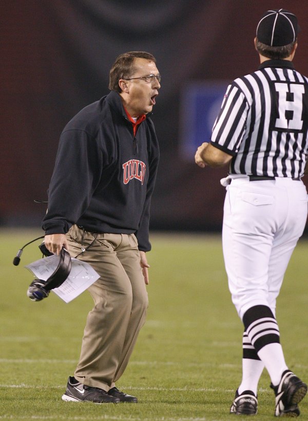 UNLV coach Mike Sanford, left, challenges a call as an ...