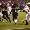 San Diego State running back Atiyyah Henderson, center, holds the ball out as he beats UNLV's Terrance Lee (23) into the end zone on a 12-yard pass reception during the fourth quarter Saturday in San Diego.  San Diego State won 42-21.