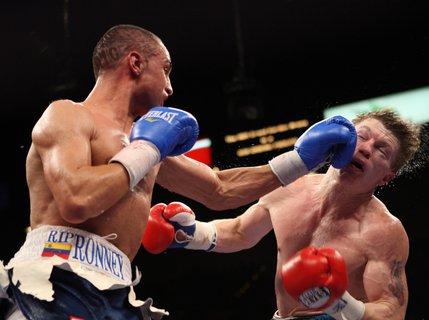 Ricky Hatton (right) of Britain takes a punch from Paulie Malignaggi of the U.S. during a junior welterweight title bout at the MGM Grand Garden Arena.