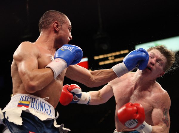 Ricky Hatton (right) of Britain takes a punch from Paulie ...