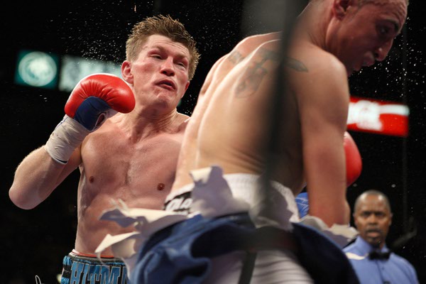 Ricky Hatton, (left) of Britain, delivers a punch to Paulie ...
