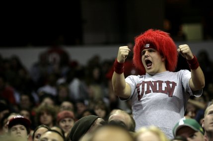 A Rebels fan stands up and dances to the music during a timeout Saturday night.