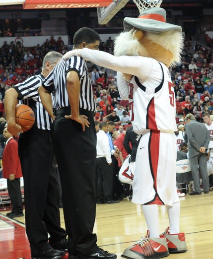 The Rebel mascot Hey Reb talks with the refs during a timeout Saturday night.