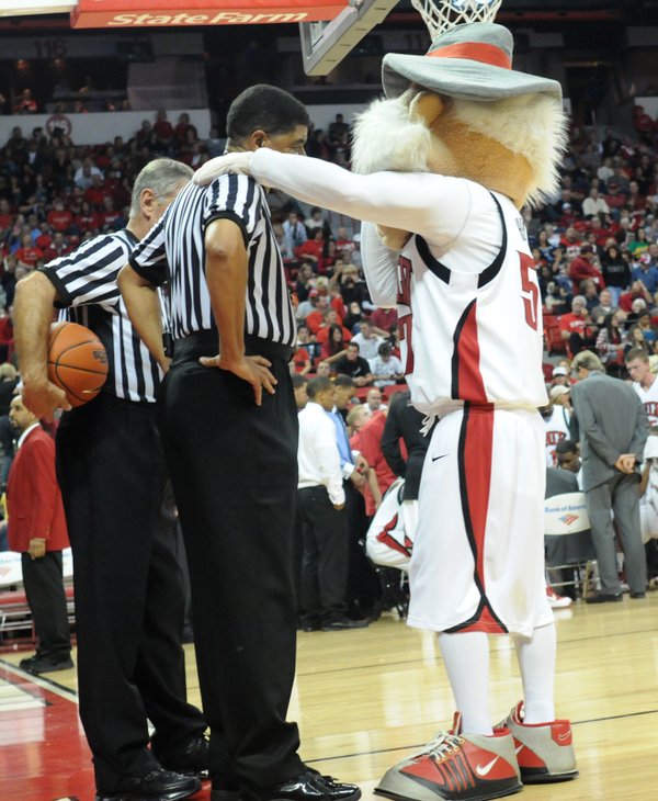 The Rebel mascot Hey Reb talks with the refs during ...