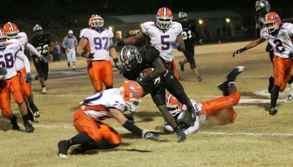 Palo Verde's Sidney Hodge (4) gets tackled by Bishop Gorman's ...