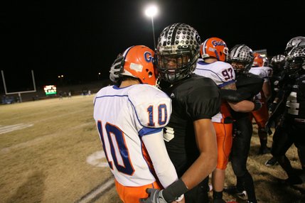 Palo Verde's Torin Harris (5), right, consoles Bishop Gorman quarterback Joe Huber (10) after defeating the Gaels 50-14 in the Sunset Regional championship game Friday.