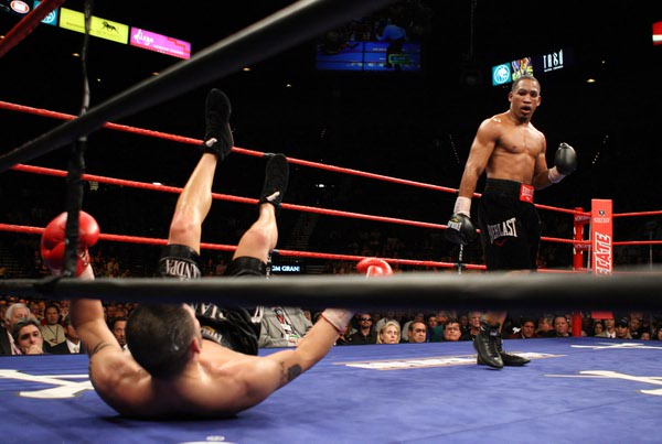 James Kirkland knocks Brian Vera to the canvas during their ...