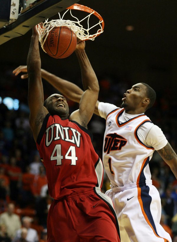 UNLV's Darris Santee, left, slam dunks over UTEP's Arnett Moultrie ...