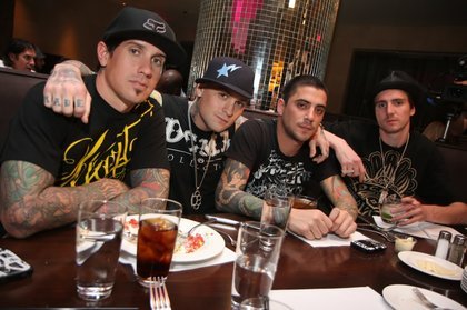 Carey Hart and Benji Madden pose with a pair of friends at N9Ne steakhouse at the Palms before partying at the Playboy Club.