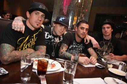 Carey Hart and Benji Madden pose with a pair of friends at N9Ne Steakhouse in the Palms before partying at The Playboy Club.