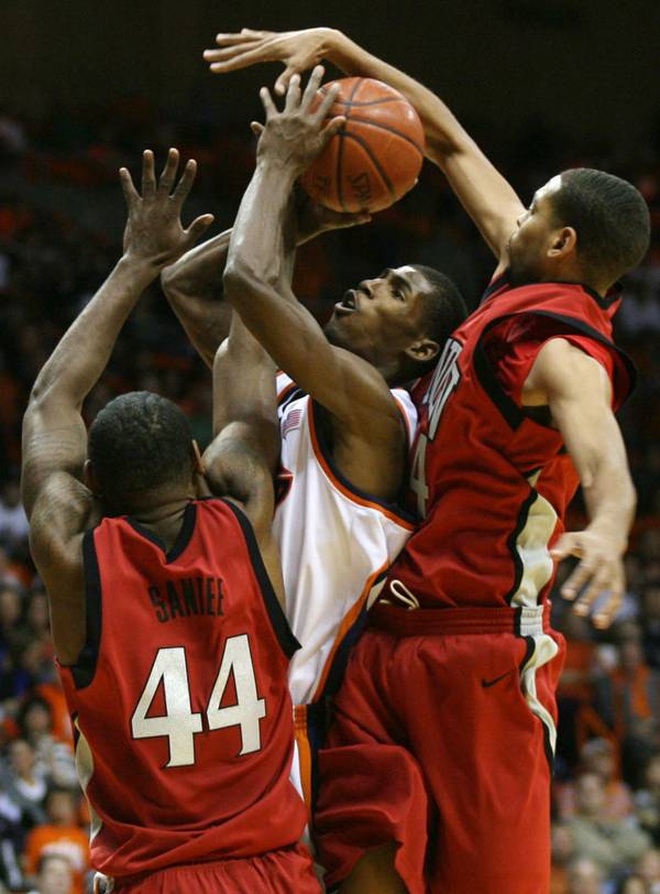 UTEP's Stefon Jackson, center, tries to put up a shot ...