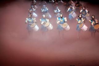 Obscured by a slight haze, drummers enter the arena where the Excalibur's long-running dinner show, 