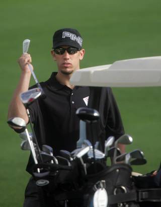 Tampa Bay Rays baseball player, James Shields, returns his club to his bag during the Inaugural College of Southern Nevada Golf Classic at Dragon Ridge Golf Club on Tuesday.